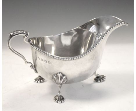 Edward VIII silver sauceboat with scroll handle and standing on three shell feet, 8.5cm high, 155g approx Condition: Two of t