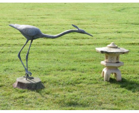 Lead garden statue in the form of a stylised heron attached to a stone base, together with a stone effect Chinese style garde