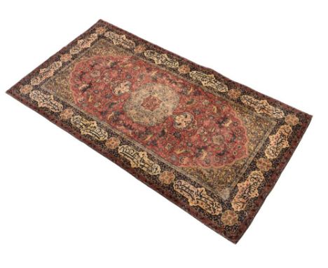 Middle Eastern-style machine-made wall hanging in the manner of a 'Hunting Carpet', the madder rose field with various wild a