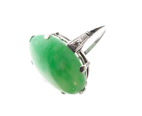 18ct white gold dress ring set large dyed jade oval cabochon approx 18mm x 13mm, between small diamonds to the shoulders, siz