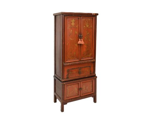 Chinese provincial pine and red lacquer cabinet of two stages, the upper with gilt-decorated doors enclosing two shelves, ove