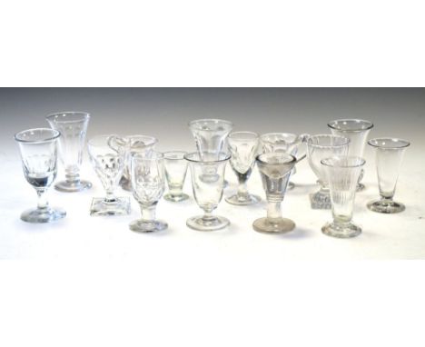 Collection of short stem drinking glasses, lemon squeezer, pedestal foot glasses, custard cups and a penny lick, early 19th C