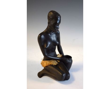 Austrian mid century ceramic figure of an African woman, applied label to base, 25cm high Condition: Wear to black glaze unde