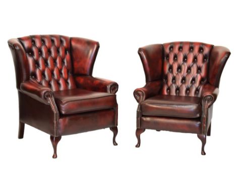Pair of deep-buttoned red leather wing arm chairs for a lady and gentleman, each with studded arm supports on cabriole front 