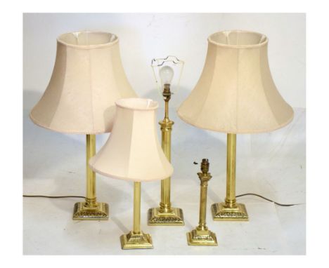 Five brass table lamps Condition: Not tested, sold as seen, one shade appears to be missing, the other shades having stains p
