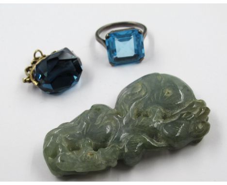 Small carved jade pendant, yellow metal swivel seal set with a blue stone and a silver ring set blue stone