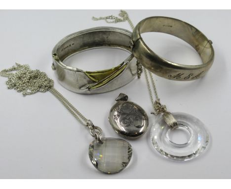 925 Silver and silver gilt bangle, another silver bangle, silver photograph locket and two silver mounted glass pendants on c