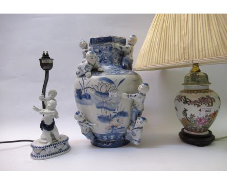 Modern oriental enamel style lamp base with pleated shade, another lamp base mounted with figures of cherubs (lacking shade) 