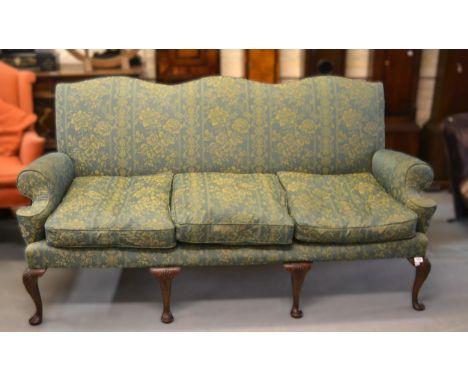 Green brocade upholstered triple humpback sofa in Georgian style, with shaped arms, raised on cabriole supports