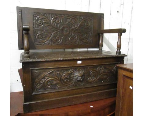 Early 20th Century carved oak monk's bench, with mask head decoration, 107cm wide x 46cm deep x 76cm high