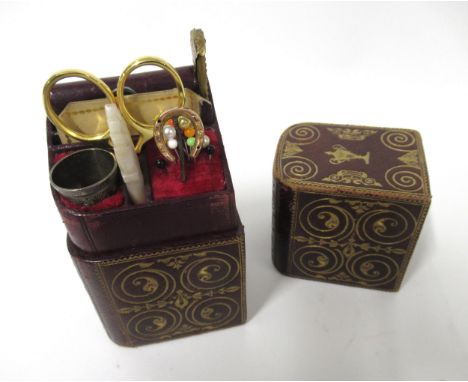 Leather cased ladies companion set with gilt tooled decoration, including various sewing implements with thimble, scissors, c