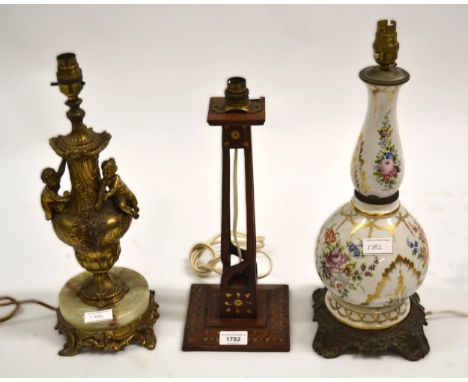 Mahogany brass inlaid table lamp, gilt metal table lamp, and a porcelain table lamp