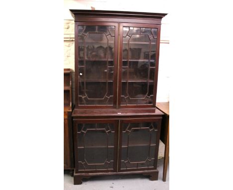 Early 20th Century Chippendale style bookcase, the moulded cornice above two pairs of bar glazed doors, on bracket feet, 206 