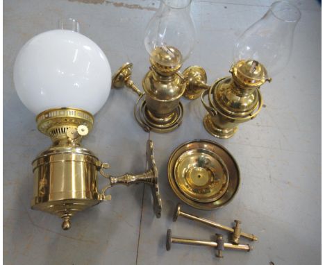 Pair of small ship's brass binnacle lamps with chimneys, wall brackets and smoke shades, together with a similar larger brass