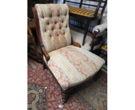 19th Century walnut button upholstered low seat nursing chair, on turned supports with casters