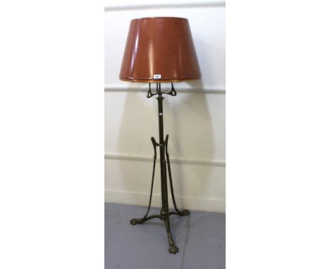 Early 20th Century brass oil lamp standard of Art Nouveau design adapted for use with electricity, the tripod base with paw s