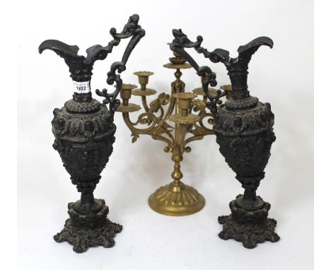 Pair of 19th Century black painted spelter jug vases, 42cm high, together with a brass five light candelabra, 37cm high, and 