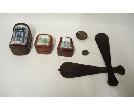 Three small 20th Century lacquer boxes with porcelain inset lids, together with a set of ten Chinese red lacquer stacking pla