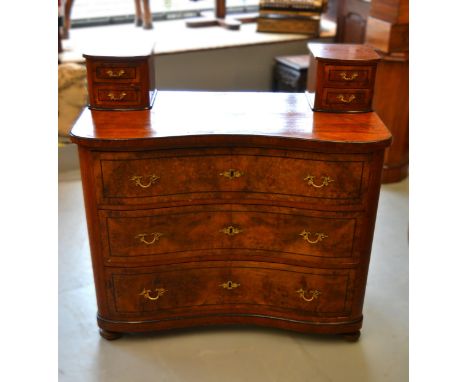19th Century Continental figured walnut three drawer commode, the plain top above an inverted serpentine front with gilt bras