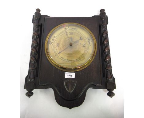 Early 20th Century oak aneroid barometer with brass dial, 17ins high