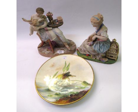Late 19th Century French bisque polychrome figure of a seated girl feeding a bird, 24cm high, together with another similar f