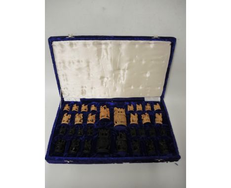 20th Century Indian carved natural and dark stained hardwood chess set in a fitted case