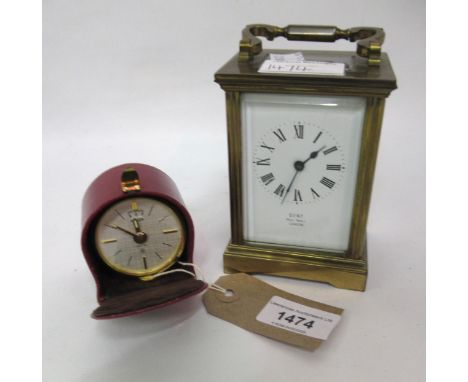 Jaeger, small gilt metal travel alarm clock in red leather case and a brass cased carriage clock with enamel dial, inscribed 