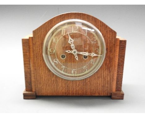 A collection of three clocks including an enamel carriage mantle clock
