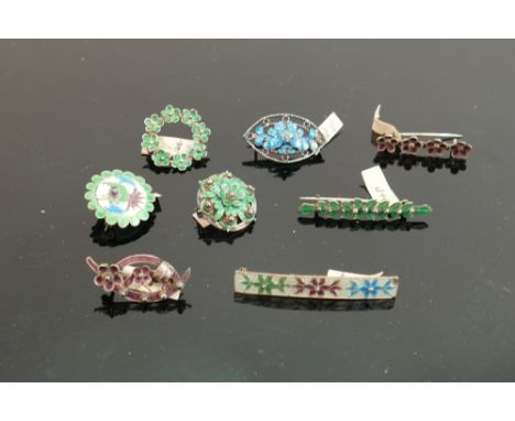 Eight silver coloured metal and enamel brooches: All bearing pre decimal price tags in ink, quoted in shillings and pence.  P