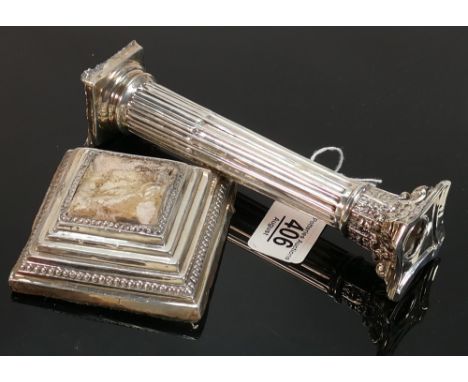 Large silver candlestick badly damaged: A loaded square based corinthian column candlestick, broken in two, with extensive en