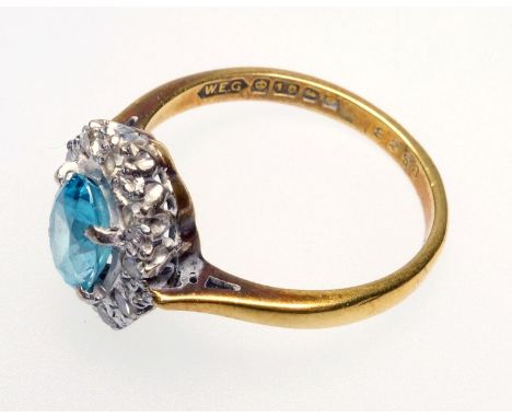 18 CT GOLD PALE BLUE TOPAZ AND DIAMOND CLUSTER RING, (SIZE L), BIRMINGHAM 1963, THE CENTRAL OVAL CLAW SET TOURMALINE (L, 7 MM