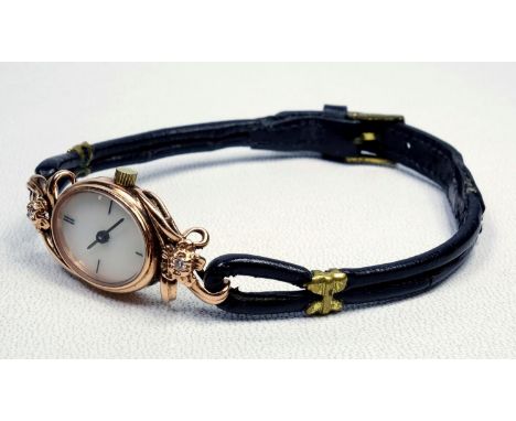 A LADY'S FRANKLIN MINT 14 K GOLD AND DIAMOND SET QUARTZ COCKTAIL WATCH,THE MOTHER OF PEARL DIAL WITH APPLIED BATON QUARTER HO