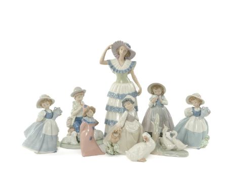 ASSORTED NAO PORCELAIN FIGURES including, children with farm animals, water pail, flower bouquet etc. tallest 32cms (h) (9)Pr