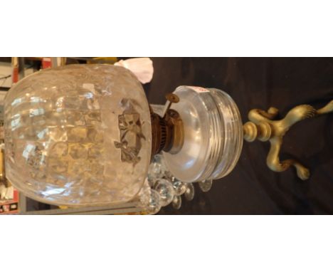 Large brass based oil lamp with glass shade and reservoir 
