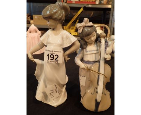 Two Nao figurines of girls one with cello 