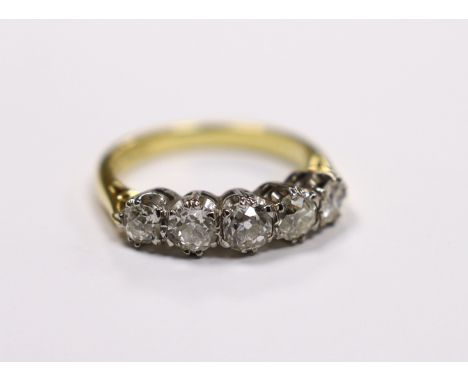 A modern 18ct gold and graduated five stone diamond set half hoop ring, size M, gross weight 4.5 grams..