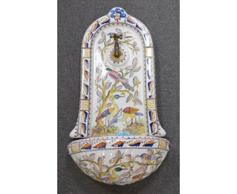 A Portuguese pottery font and basin, hand painted with birds and flowers, 66cm high