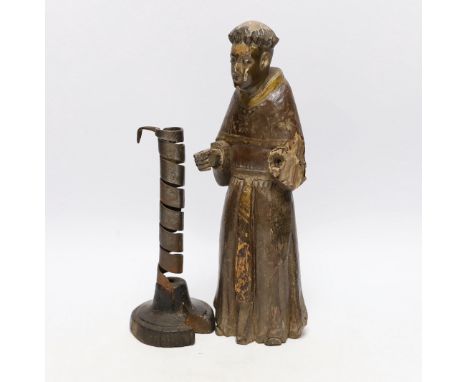 An 18th century Spanish carved and painted wood figure of a monk and 18th century ‘rat de cave’ candlestick, wooden knight 32