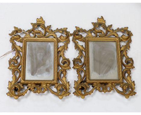 A pair of gilt metal, Rococo style easel mirrors and a carved wood photo frame, largest overall 30cm high
