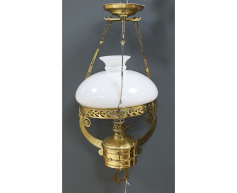 A late 19th century German brass hanging lamp, with oil reservoir and opaque glass shade, approximately 70cm long