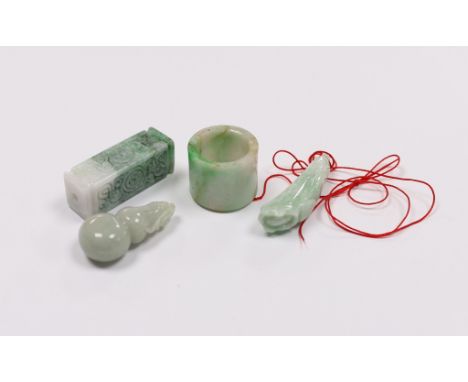 Four Chinese jadeite carvings including an archers ring