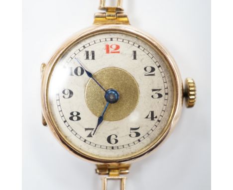 An early 20th century 9ct gold manual wind wrist watch, on a 9ct expanding bracelet, case diameter 25mm, gross weight 14.9 gr