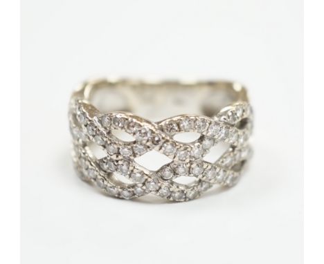 A modern 14k white metal and diamond chip cluster set dress ring, of interwoven design, size M, gross weight 6.4 grams.