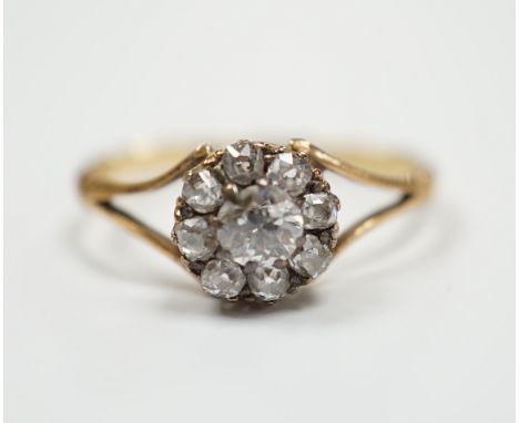 An early 20th century 18ct and old round cut diamond set circular cluster ring, size Q, gross weight 2.7 grams.