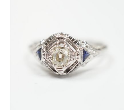 An 18ct and single stone diamond set ring, with two stone triangular sapphire set shoulders, size P, gross weight 3.1 grams.