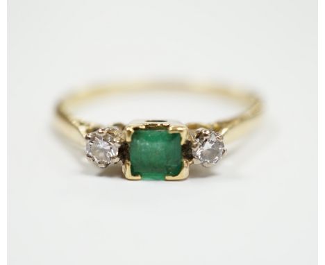 An 18ct and plat, single stone emerald and two stone diamond set ring, size Q/R, gross weight  2.6 grams.