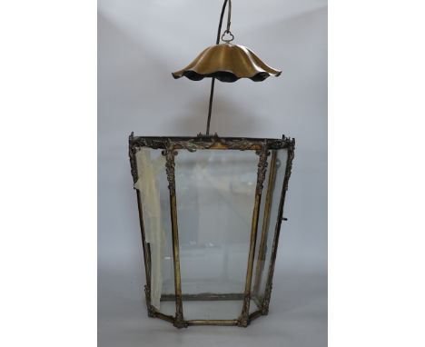 A 19th century brass framed porch lamp with applied scrolled decoration, 65cm high