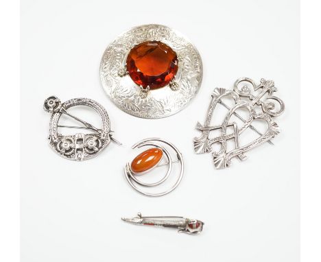 A 1950's Scottish silver and citrine coloured paste set circular brooch, 68mm, an Edwardian silver Celtic style brooch and th