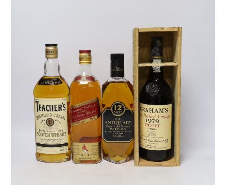 A bottle of The Antiquary Scotch Whisky, a bottle of Teachers and a bottle of Johnnie Walker, plus a cased bottle of Vintage 