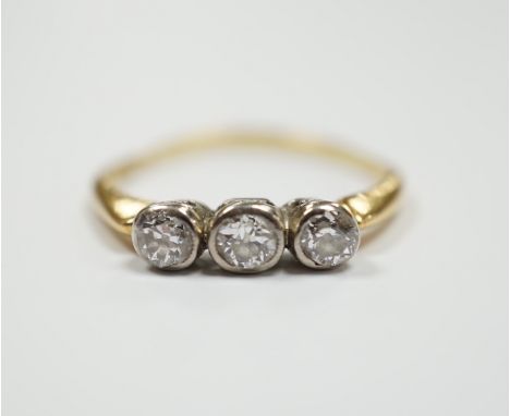 An 18ct and collet set three stone diamond ring, size R, gross weight 2.6 grams.